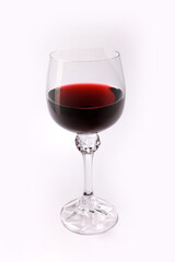 Beautiful glass with red wine on a white background. Transparent glass on a white background
