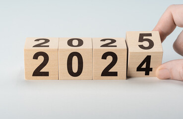 2025 happy new year, Flipping of wooden cube block change from 2024 to 2025. Wooden cube with flip...