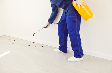 Midsection shot of a man, pest control worker wearing workwear and using a potent insecticide spray...