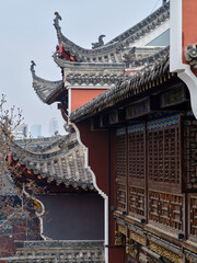 decorated roof, carved wooden windows and painted stone wall of a Chinese Taoism temple