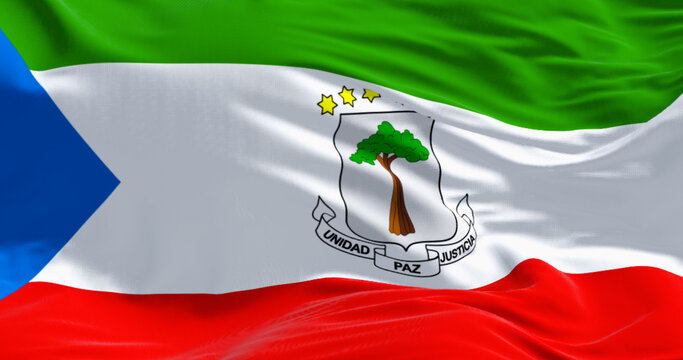 National flag of Equatorial Guinea waving in the wind on a clear day - Powered by Adobe