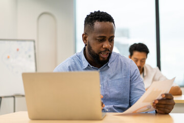 Young african amarican businessman work relaxing using technology laptop on table at office.Young creative man working and typing on keyboard, technology, online, email, job, project on workplace