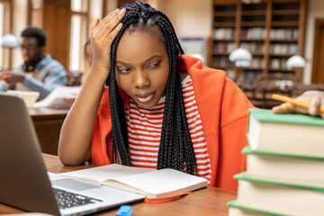 Long-haired young woman studying in the library