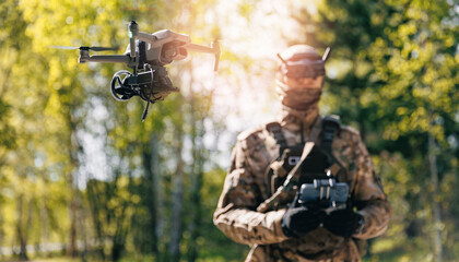 Military soldier operator of fpv UAV control drone with device for releasing bombs and grenades to enemy positions