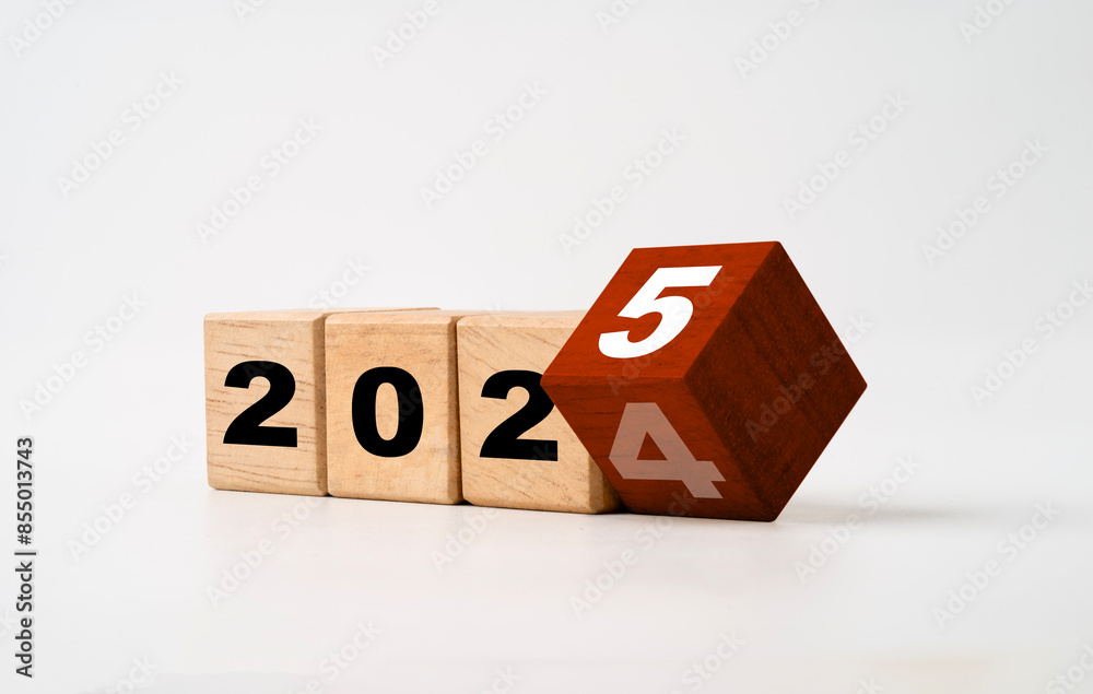 Wall mural flipping of 2024 to 2025 on red wooden block cube for preparation new year change and start change n