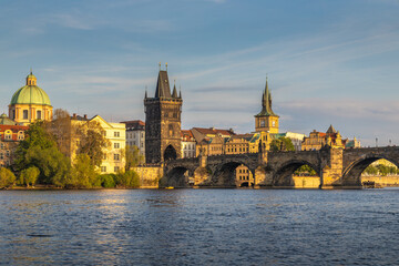 Fototapeta premium Charles Bridge with towers in Prague in beautiful light at sunset, Czech Republic, Europe.