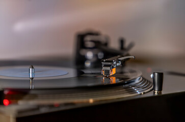 Close up of turntable stylus (needle) on black vinyl record