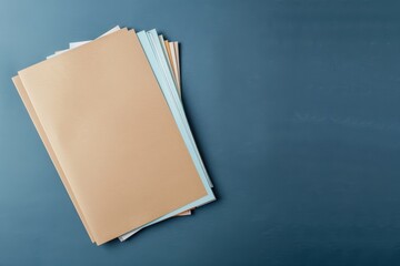 Stack of folders on a dark blue background, representing organization, paperwork, and office supplies.