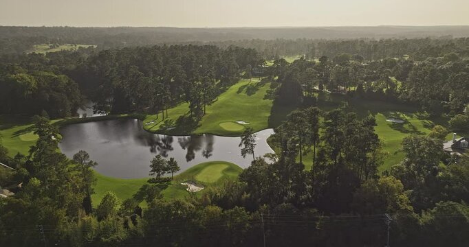 Augusta Georgia Aerial v59 cinematic drone flyover around the National Golf Course, capturing sunset views of the lush fairways, lake, and cityscape - Shot with Mavic 3 Pro Cine - October 2023