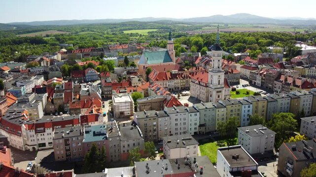 Prudnik's historic center, featuring the prominent church, town hall, and scenic surrounding countryside. Prudnik, Poland - Prudnik, Polska