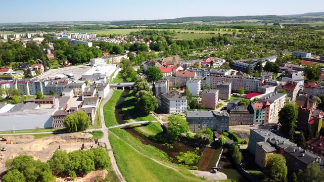 Town of Prudnik with its scenic river, historic buildings, and expansive countryside in the backdrop. Prudnik, Poland - Prudnik, Polska