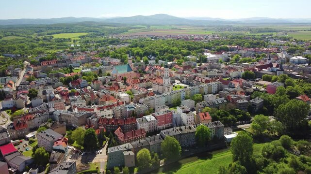 Historic buildings, lush greenery, and scenic countryside in the background. Prudnik, Poland - Prudnik