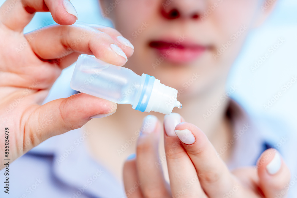 Poster young woman dripping a medical drop on her finger