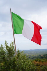 The Italian flag flutters in the wind. Close-up of the Italian banner, soft and smooth silk.