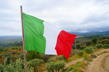 The Italian flag flutters in the wind. Close-up of the Italian banner, soft and smooth silk.