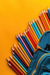 A blue backpack with a bunch of colored pencils on top of it
