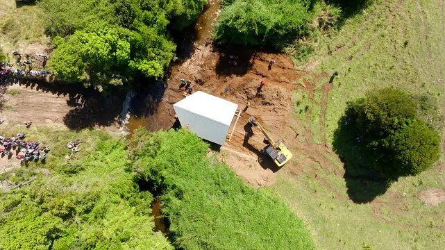 Aerial Birds Eye View Of Excavator Position House Near River Crossing In Chiloe, Chile. Dolly Left Shot