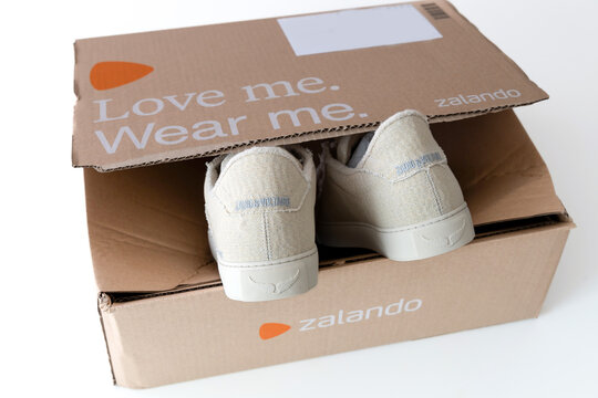 A pair of new shoes in a box. Beige sneakers from the brand Zadig and Voltaire. Delivery from the Zalando online store.