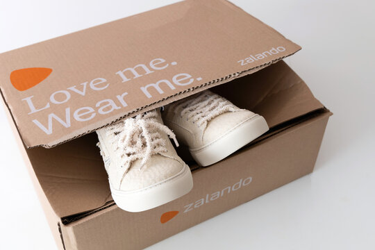 A pair of new shoes in a box. Beige sneakers from the brand Zadig and Voltaire. Delivery from the Zalando online store.