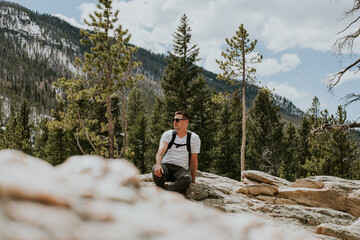 Hiker Resting in Colorado Mountain Forest Landscape