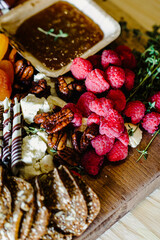 Delicious Charcuterie Board with Fresh Raspberries, Nuts, and Cheese