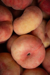 box of small, ripe, peaches