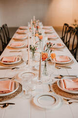 Elegant wedding reception table with peach, spring decorations
