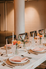 Elegant wedding reception table setting with peach, spring decorations
