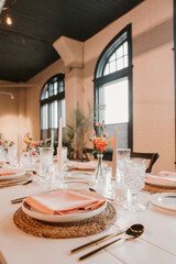 Elegant wedding reception table setting with peach, spring decorations