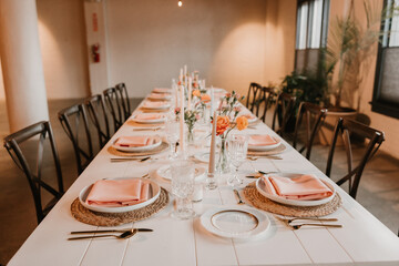 Elegant wedding reception table setting with peach, spring decorations
