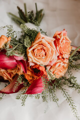 Bridal bouquet with peach roses and magenta calla lilies