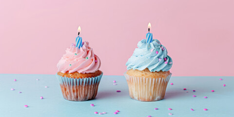 Two cupcakes with candles on top, one pink and one blue