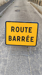 les mots route barrée écrit en français sur un panneau routier