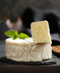 brie camembert cheese on a dark board