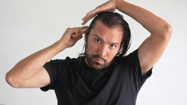 man using brush on his head with baldness, Hair health