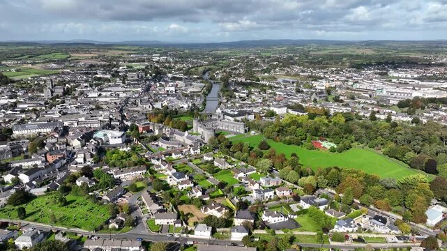 Kilkenny Castle, County Kilkenny, Ireland, September 2023. Drone at a higher angle pushes towards the  Kilkenny Design Workshop with the Church of Saint John the Evangelist in the distance.