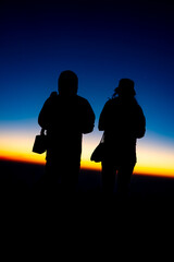 Adventure Friendship at Sunset: Silhouetted Group of Friends Embrace Nature's Beauty, Summer Journey of Hiking and Trekking Together in Majestic Mountain Landscapes, Enjoying Outdoor Activities