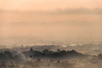 Borobudur temple and the surroundings covered by mist during sunrise