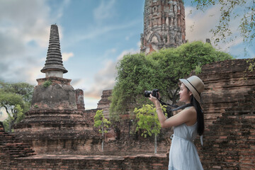 Historical local travel Thai concept, Happy traveler asian woman with dress sightseeing in Wat Phra Si Sanphet temple with pagoda background, Ayutthaya historical park, Ayutthaya, Thailand
