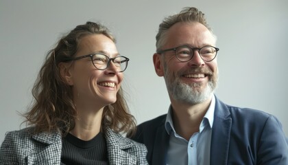 Smiling Man and Woman Wearing Glasses in a Studio Setting