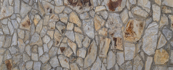 Natural stone texture, panoramic image with various colors: gray, ochre, and red