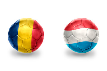 football balls with national flags of luxembourg and romania,soccer teams. on the white background.