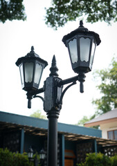 Vintage black street lamp with three lanterns