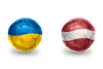 Fototapeta premium football balls with national flags of latvia and ukraine,soccer teams. on the white background.