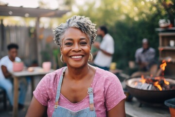 Portrait of a smiling senior African American woman at backyard barbecue