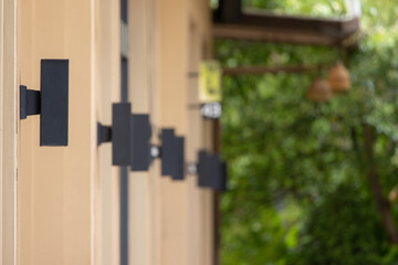 A row of black light fixtures are mounted on the wall