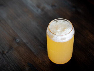 Craft banana cider on the table, copy space