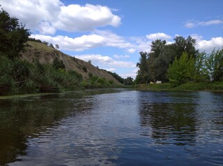 Scenery. Hills, mountains, river, nature. Trees, horizon, sky. A good day.
