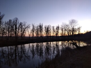 Evening on the river. Sunset, trees, river, sky.
