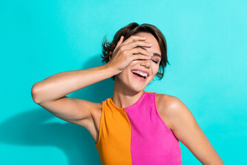 Photo of dreamy cheerful lady dressed colorful top arm cover closed eye laughing isolated turquoise color background